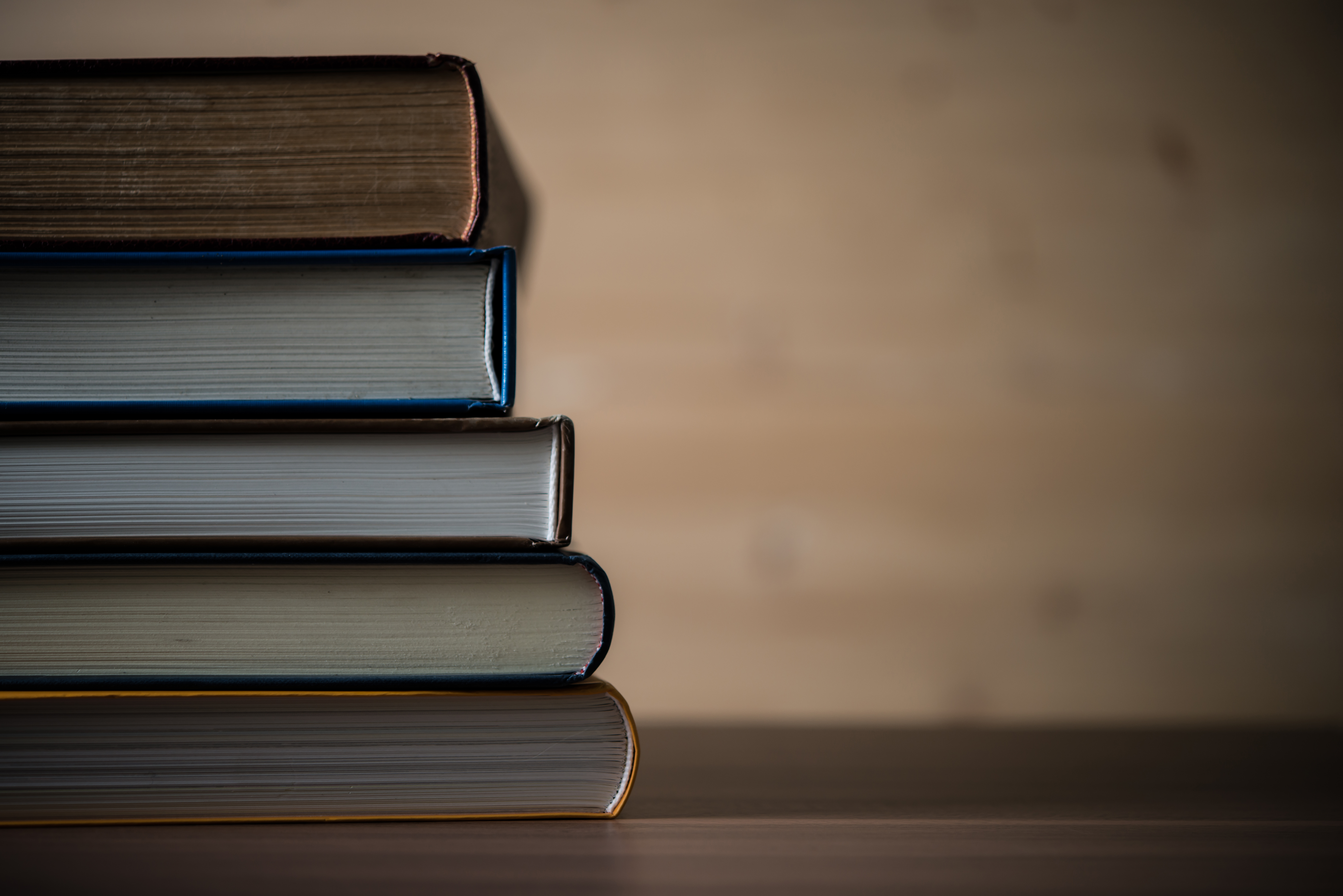 Stack of books on wooden table. Education concept.